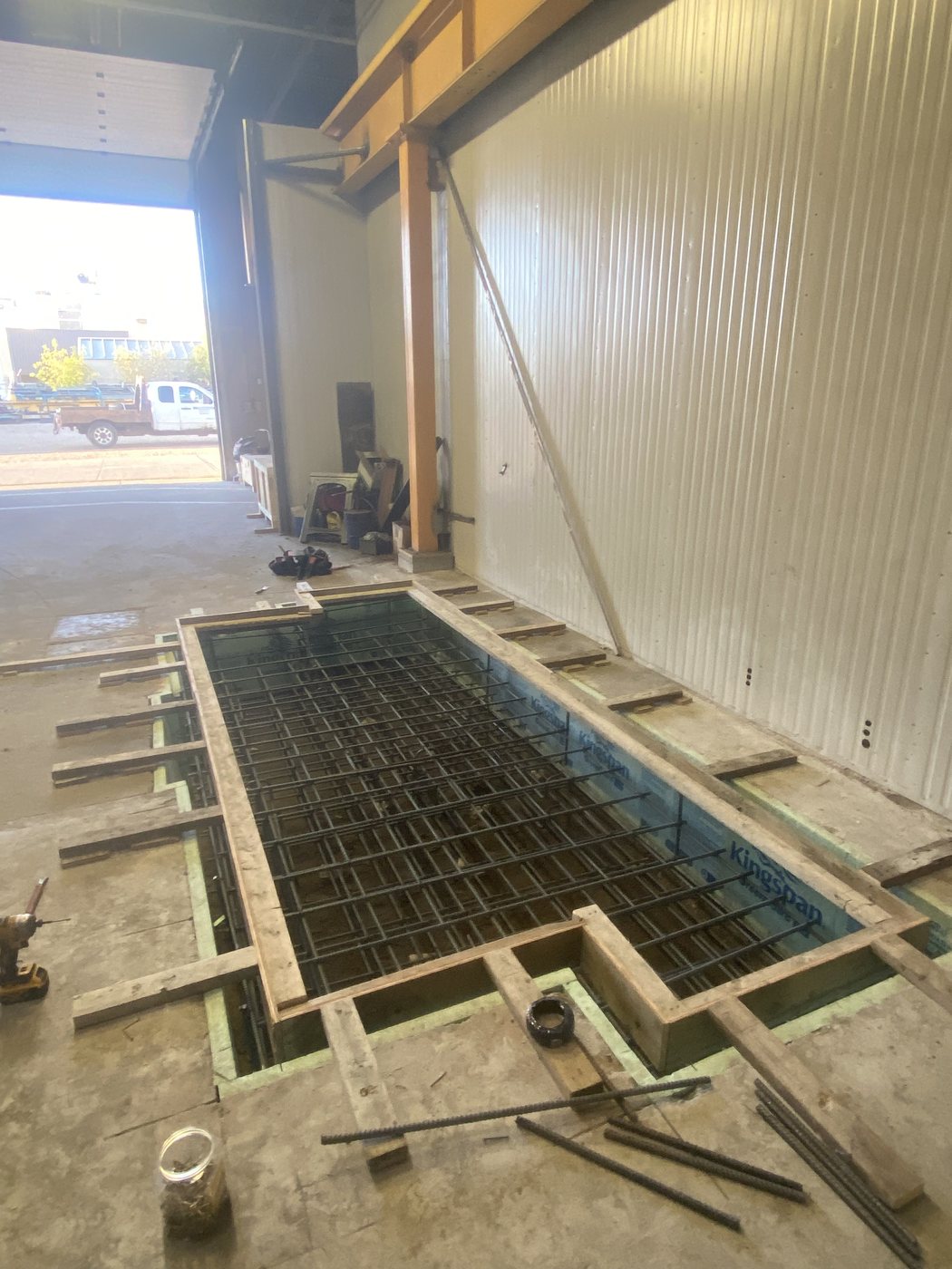 Formed and reinforced foundation for a horizontal boring lathe